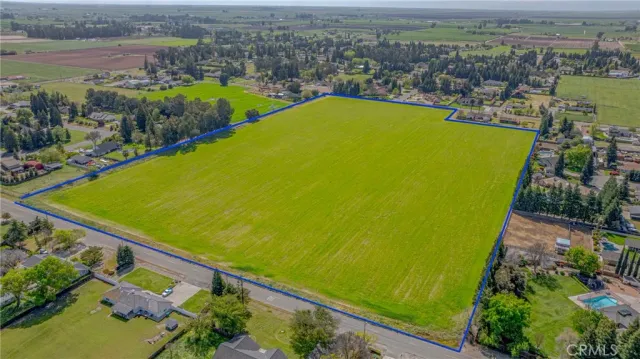 an aerial view of a residential houses with outdoor space and river view