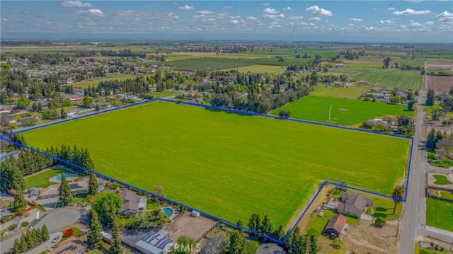 an aerial view of a residential houses with outdoor space and swimming pool