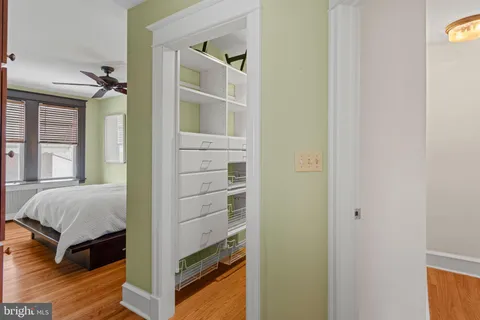 a view of bedroom with a bed and wooden floor