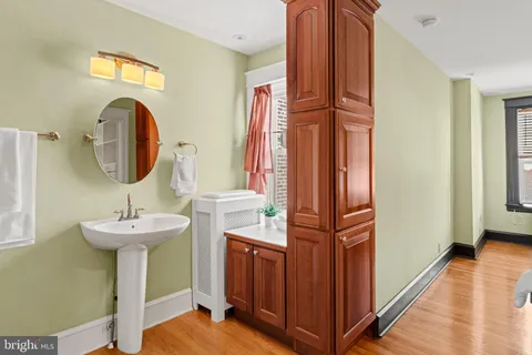 a bathroom with a sink a mirror and a shower