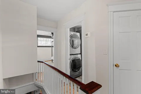 a view of a hallway with washer and dryer