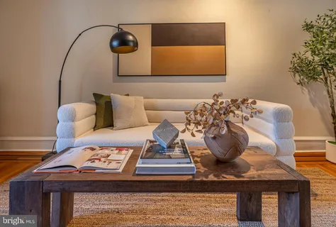 a living room with furniture and flowers