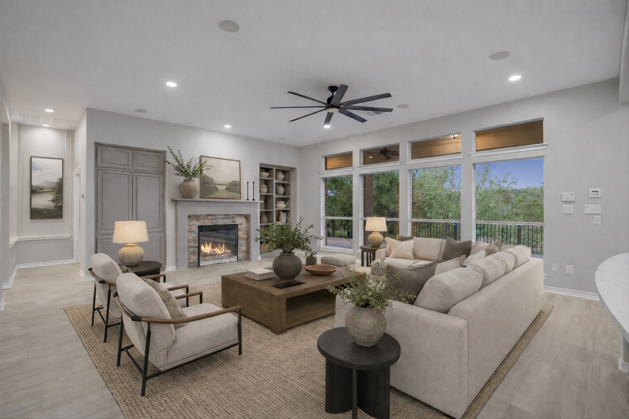 1400 Tom Sawyer Road Austin, TX 78737 - Photo 10 of 40 Spacious main living area with fireplace and wall of windows overlooking the backyard.