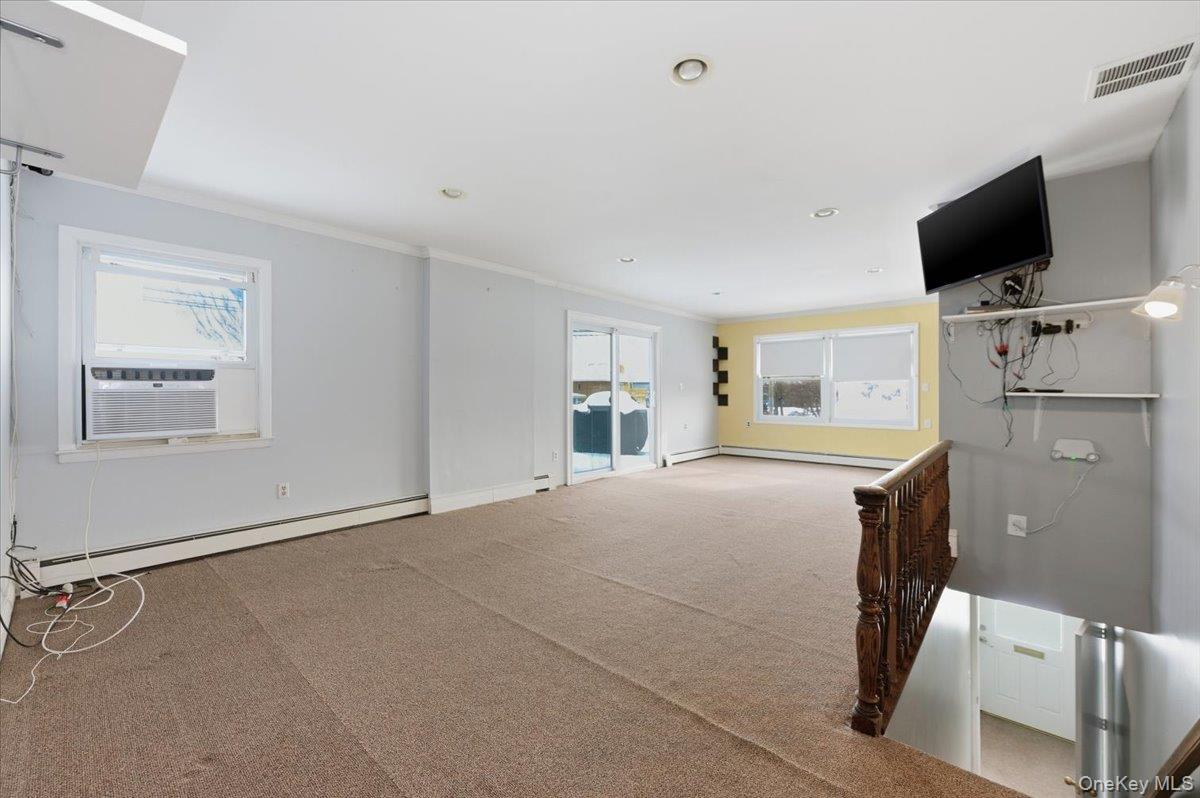 401 West Walnut Street, Unit UPPR Long Beach, NY 11561 - Photo 2 of 17 a view of a livingroom with a flat screen tv