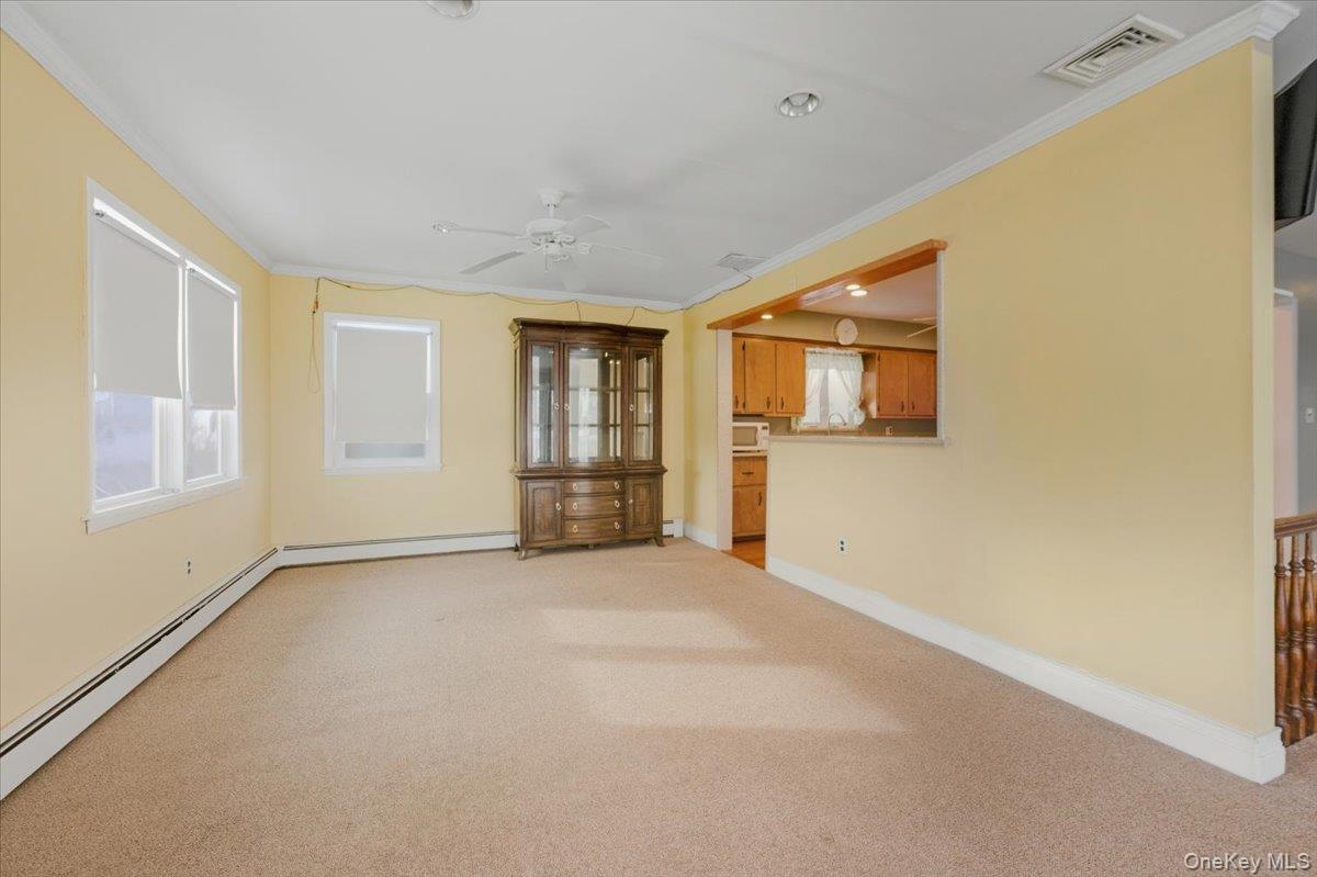 401 West Walnut Street, Unit UPPR Long Beach, NY 11561 - Photo 5 of 17 a view of an empty room with a window