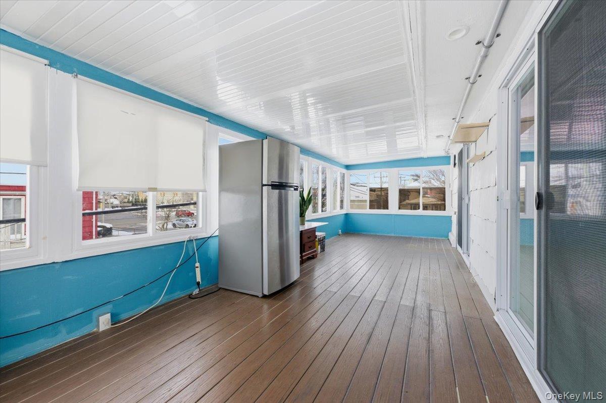 401 West Walnut Street, Unit UPPR Long Beach, NY 11561 - Photo 8 of 17 a view of a kitchen with wooden floor and a refrigerator