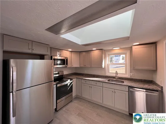 a white refrigerator freezer sitting inside of a kitchen