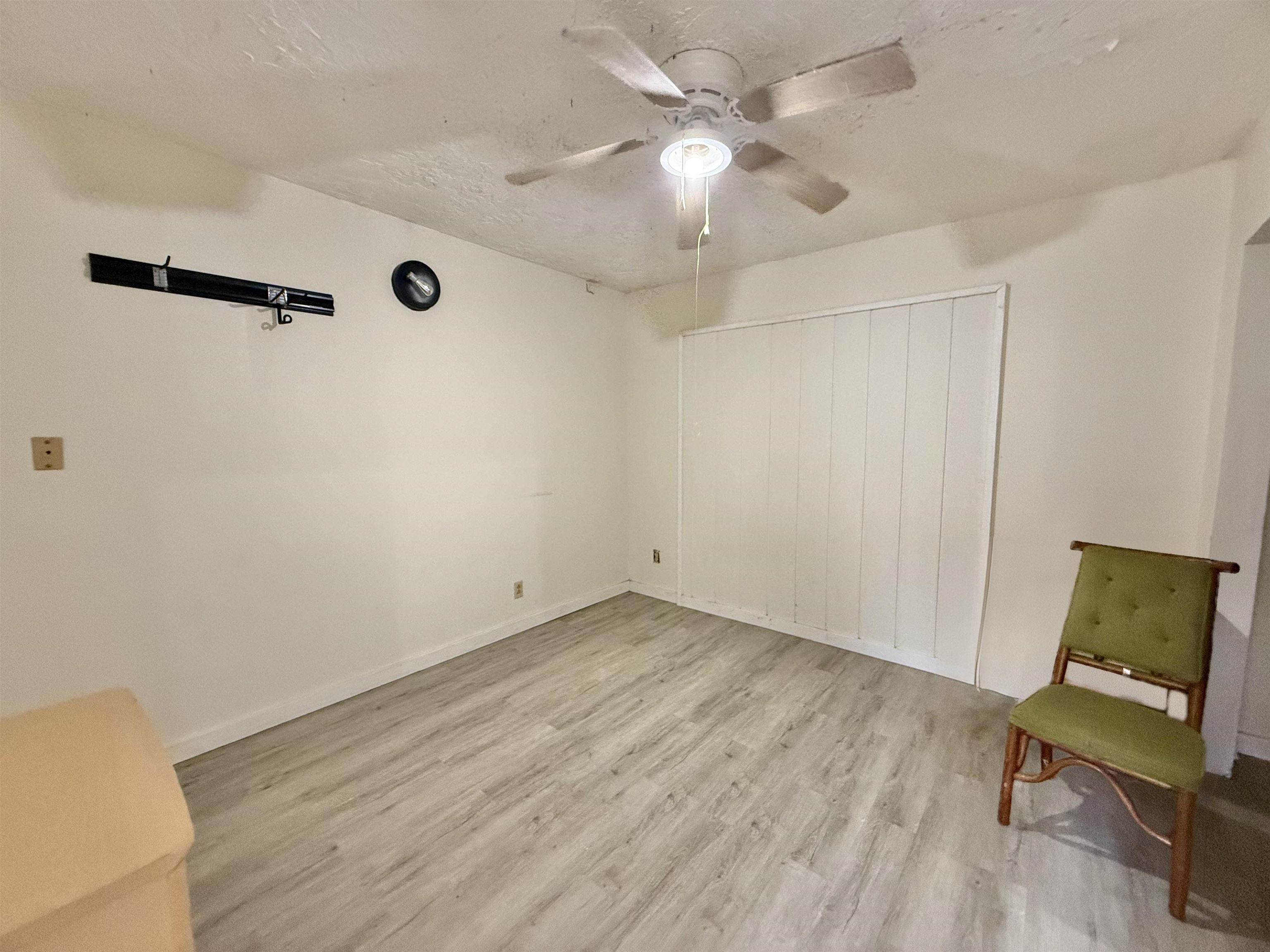 1630 Kauhikoa Road Haiku, HI 96708 - Photo 15 of 48 an empty room with wooden floor fan and windows
