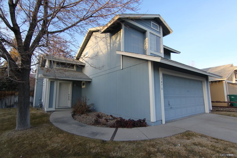 a view of a house with a yard garage and outdoor seating