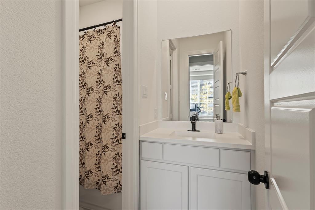 5009 Duck Cv Circle Royse City, TX 75189 - Photo 17 of 34 a bathroom with a sink a mirror and shower
