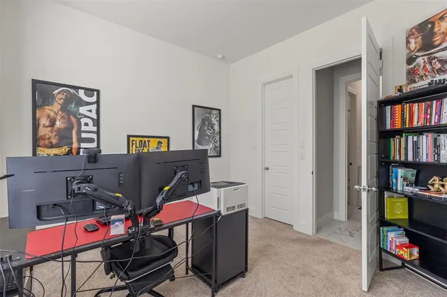 a view of a workspace with furniture and a window