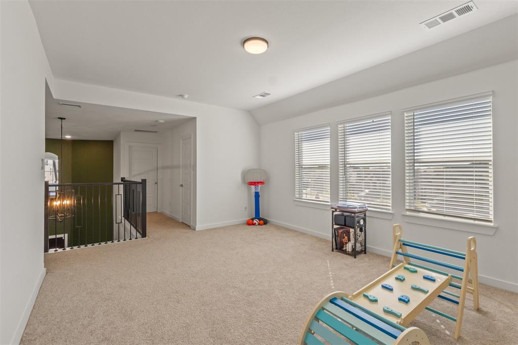 5009 Duck Cv Circle Royse City, TX 75189 - Photo 21 of 34 a bedroom with furniture and a window