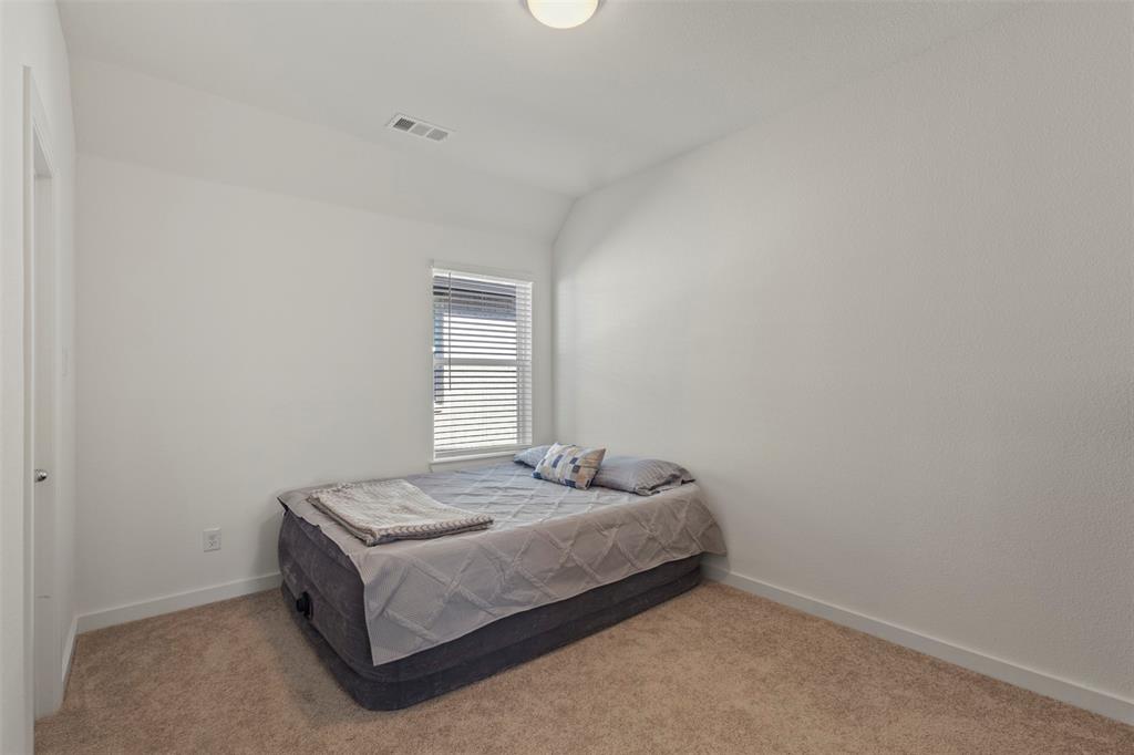 5009 Duck Cv Circle Royse City, TX 75189 - Photo 22 of 34 a bedroom with a bed and window