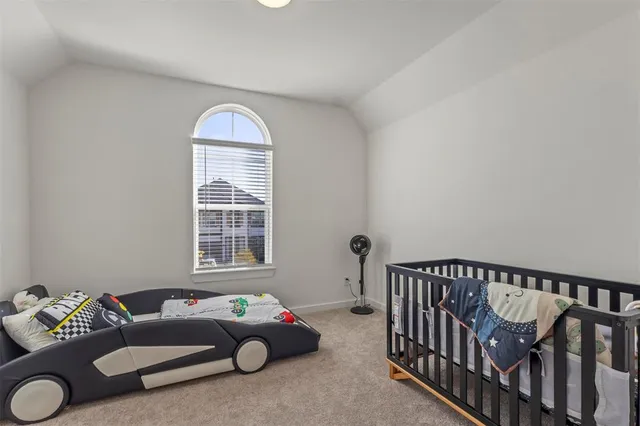 a bedroom with furniture and a window