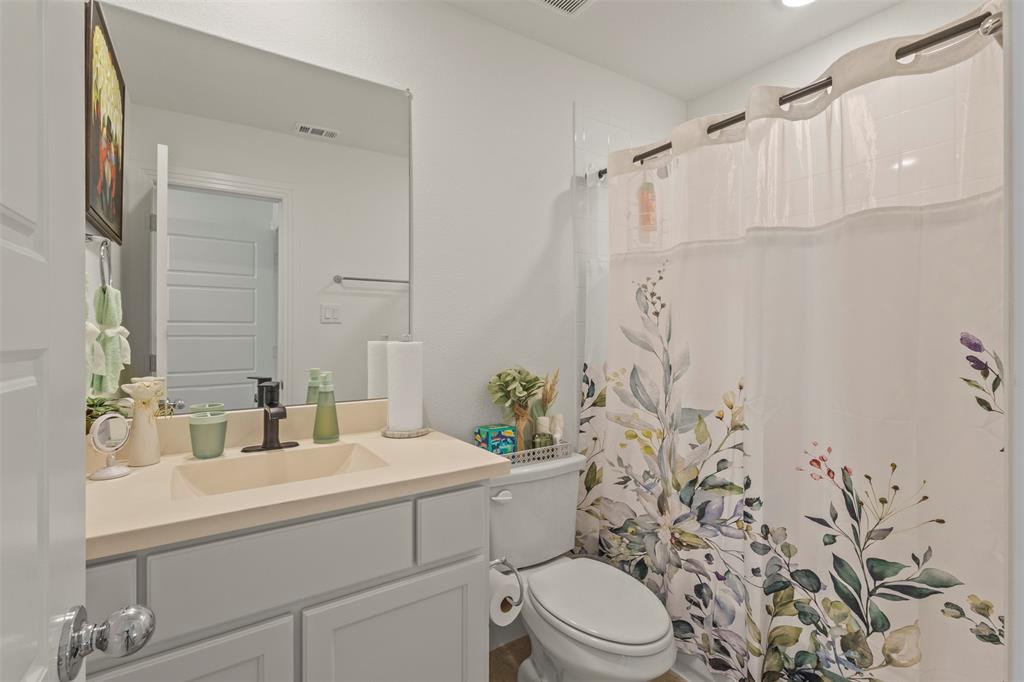 5009 Duck Cv Circle Royse City, TX 75189 - Photo 28 of 34 a bathroom with a sink a toilet and shower curtain