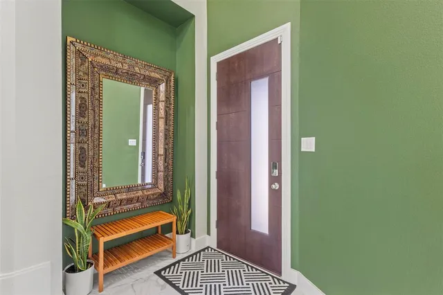 a view of a hallway with a door and a mirror