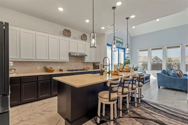 a picture of a bench in front of a white house