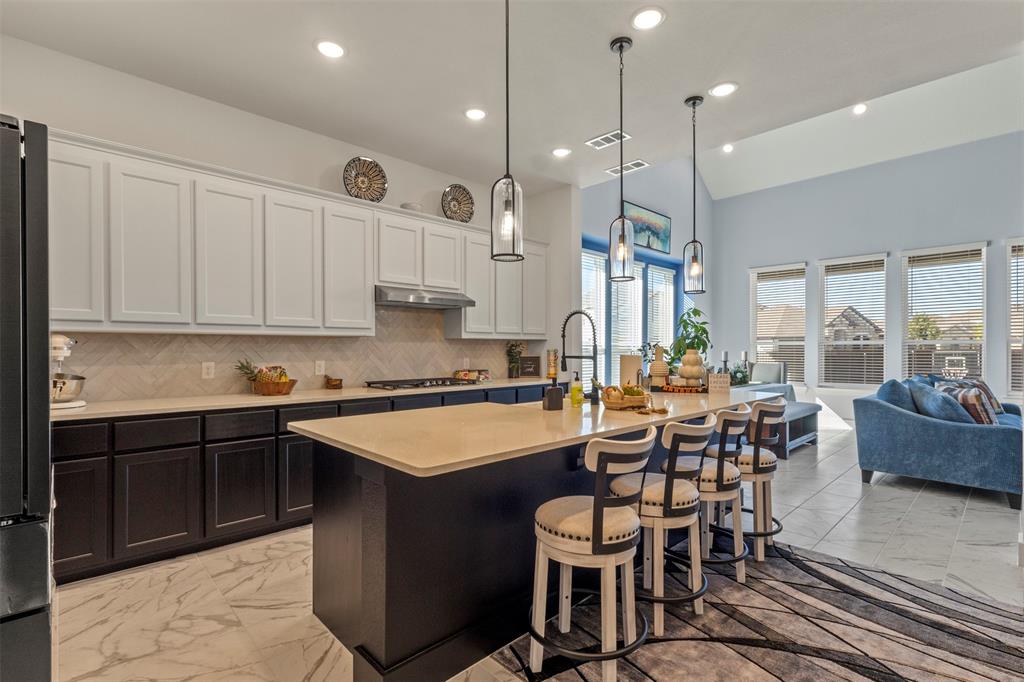 5009 Duck Cv Circle Royse City, TX 75189 - Photo 33 of 34 a large kitchen with lots of counter space and dining table