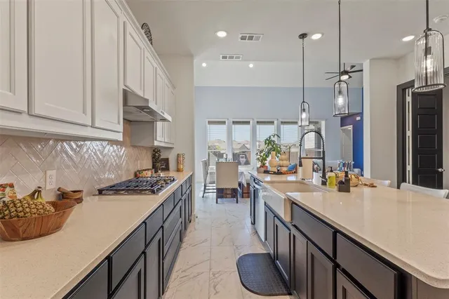 a large kitchen with lots of counter space and dining table