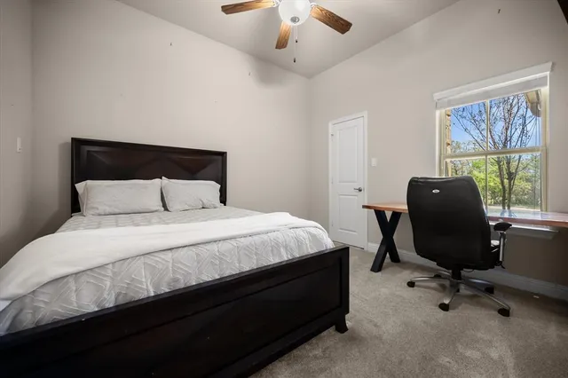 a bedroom with a bed a desk and a dresser