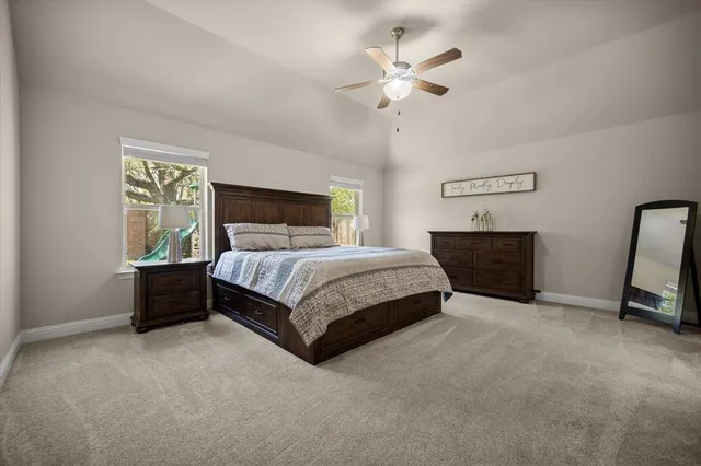 a bedroom with a bed chandelier and a window