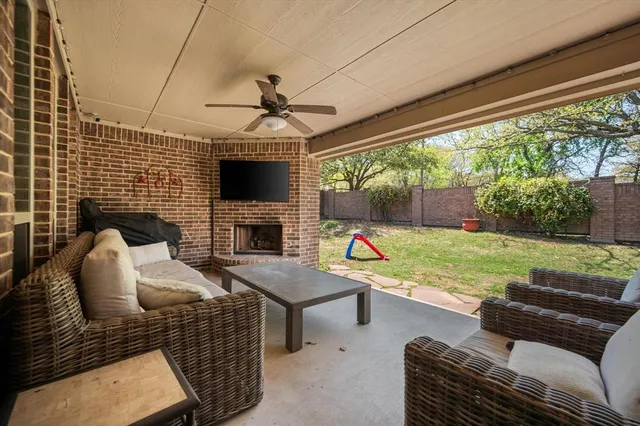 a view of a patio with couches chairs and a floor to ceiling window