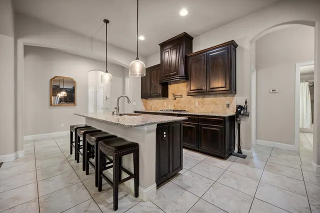 a kitchen with stainless steel appliances granite countertop a stove and a wooden cabinets