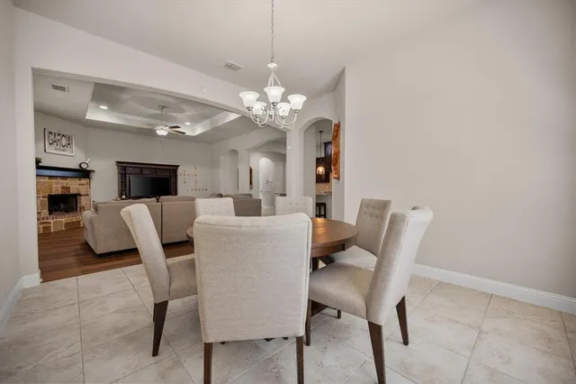 a view of a dining room with furniture and a chandelier