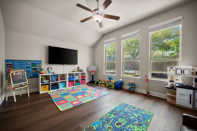 a bedroom with furniture and a flat screen tv
