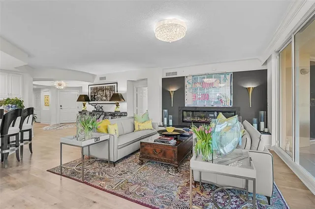 a living room with furniture a piano and a window