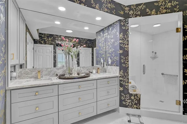 a bathroom with a granite countertop sink toilet and shower