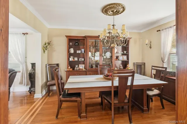 a view of a dining room with furniture and chandelier