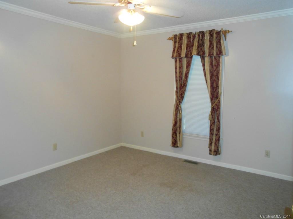 1347 Lee Ormand Road Lancaster, SC 29720 - Photo 13 of 18 an empty room with a ceiling fan and wooden floor
