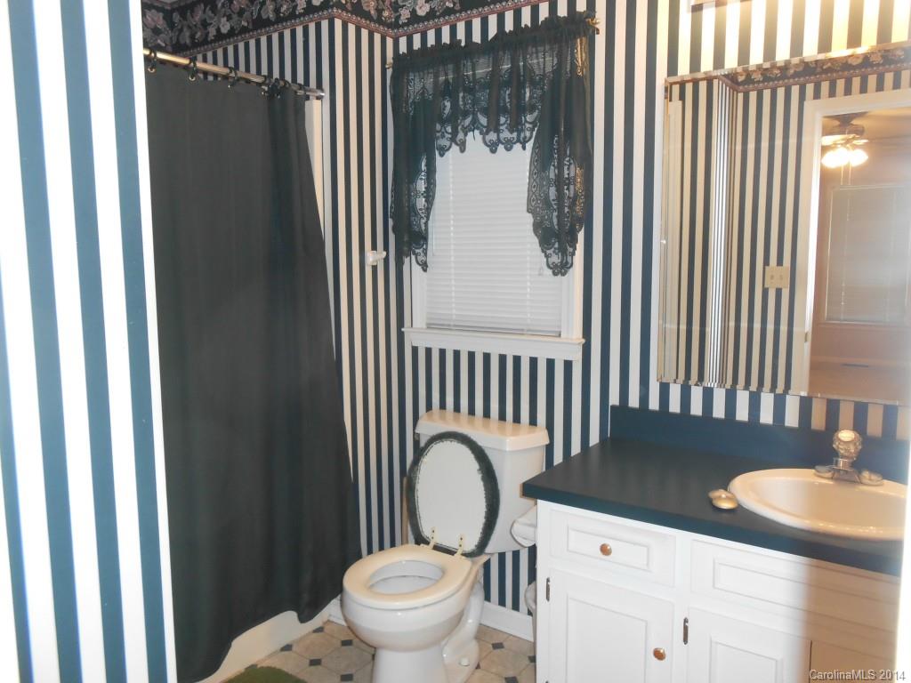 1347 Lee Ormand Road Lancaster, SC 29720 - Photo 18 of 18 a bathroom with a granite countertop toilet and a sink