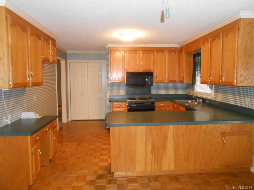 1347 Lee Ormand Road Lancaster, SC 29720 - Photo 9 of 18 a kitchen with kitchen island granite countertop a sink stove and cabinets