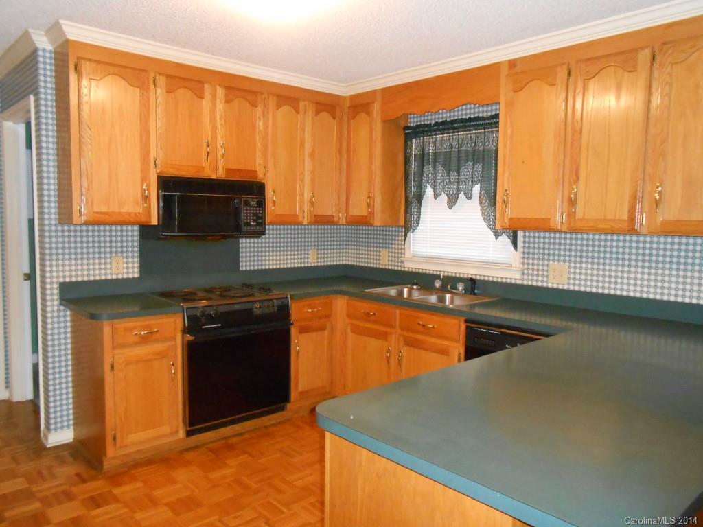1347 Lee Ormand Road Lancaster, SC 29720 - Photo 10 of 18 a kitchen with stainless steel appliances granite countertop a stove a sink and a microwave