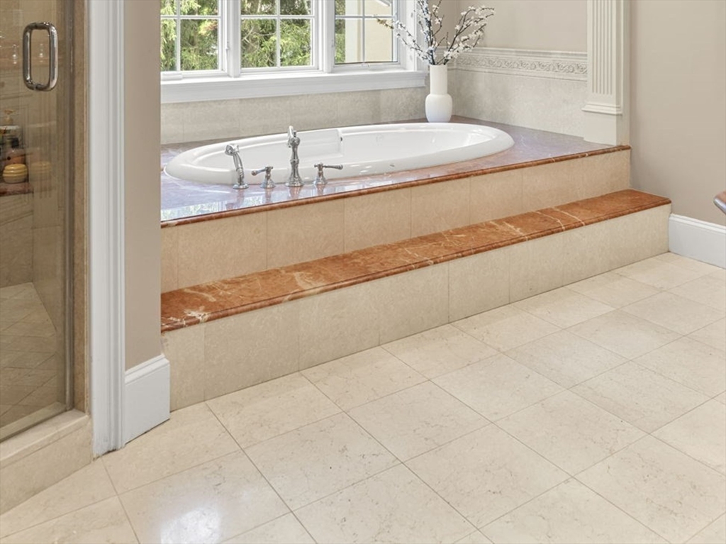 22 Scotney Road Newton, MA 02467 - Photo 27 of 42 a bathroom with a bathtub and a shower