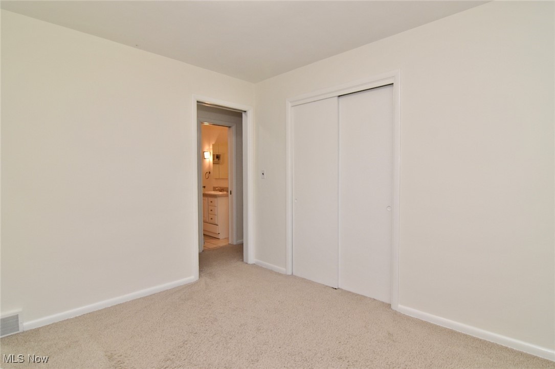 981 Hanley Road Cleveland, OH 44124 - Photo 26 of 42 Unfurnished bedroom featuring carpet floors and a closet