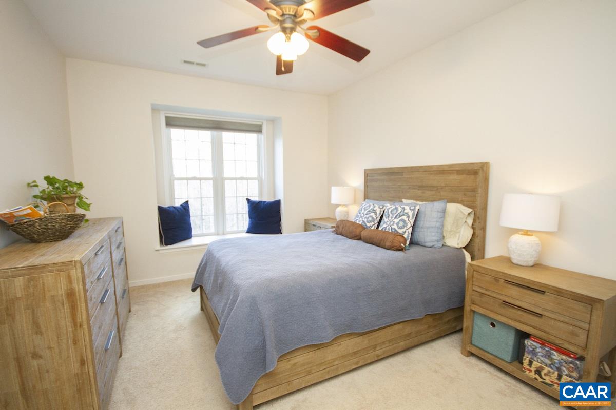 316 Starcrest Road Charlottesville, VA 22902 - Photo 11 of 33 a bedroom with a bed and a chandelier