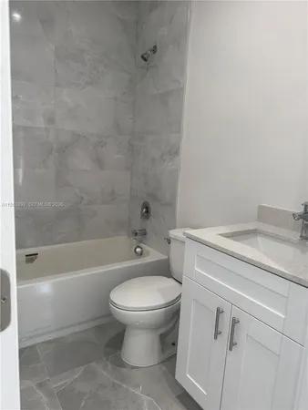 a bathroom with a sink a toilet and a bathtub