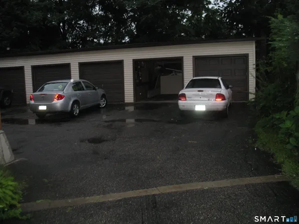 a front view of a house with parking space