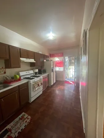 a kitchen with stainless steel appliances kitchen island granite countertop a stove a sink and a refrigerator