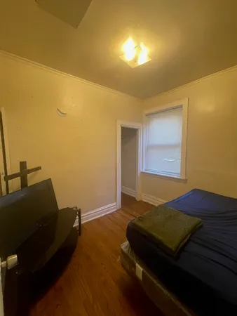 a bedroom with bed and window