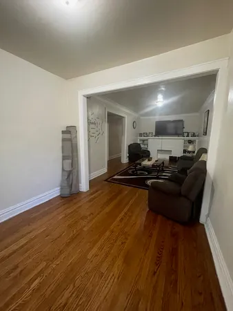 a living room with couch and wooden floor