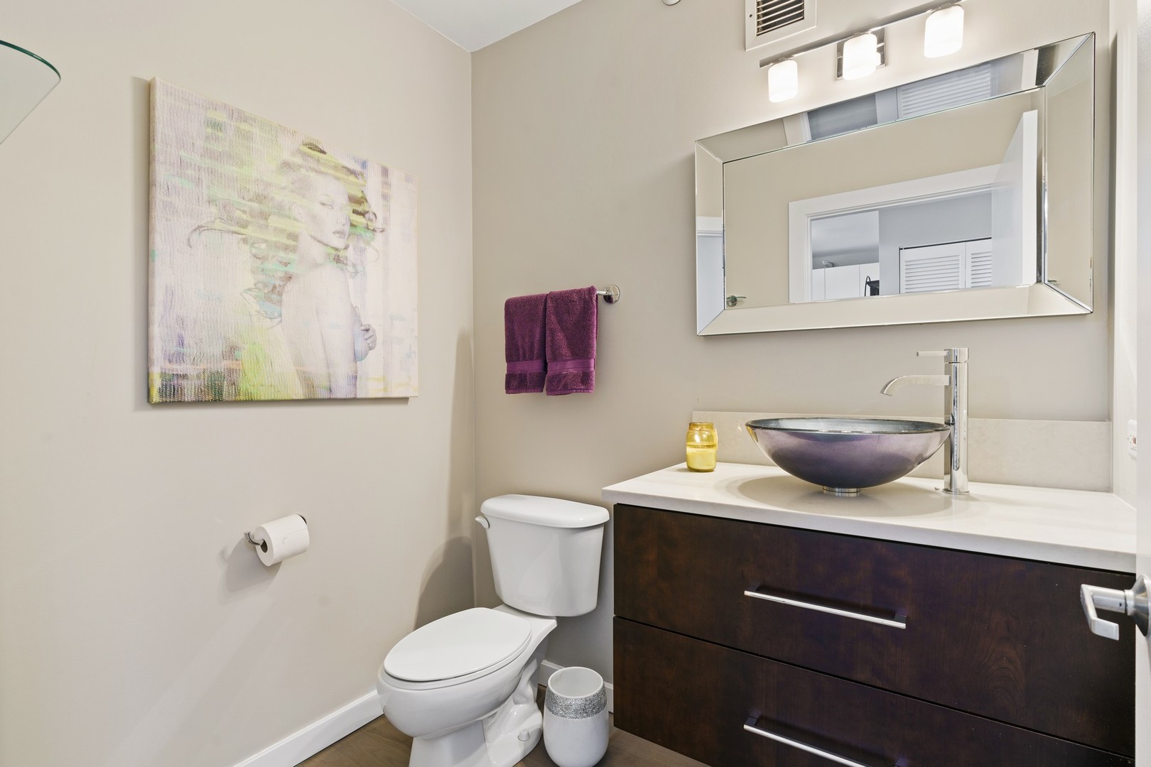 630 North State Street, Unit 2210 Chicago, IL 60654 - Photo 14 of 23 a bathroom with a toilet a sink and mirror