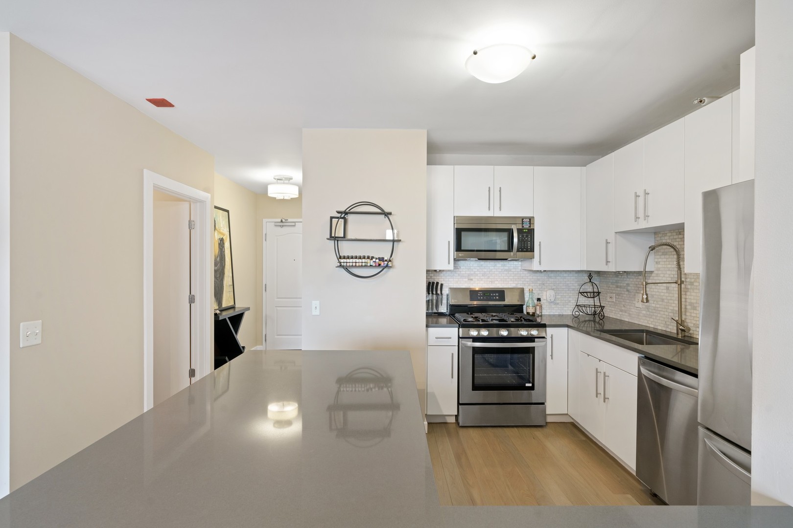 630 North State Street, Unit 2210 Chicago, IL 60654 - Photo 8 of 23 a kitchen with stainless steel appliances a stove sink and refrigerator