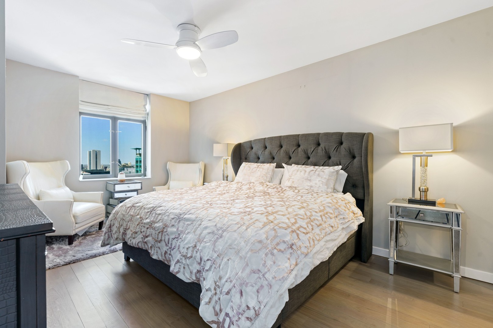 630 North State Street, Unit 2210 Chicago, IL 60654 - Photo 9 of 23 a bedroom with bed and a chandelier