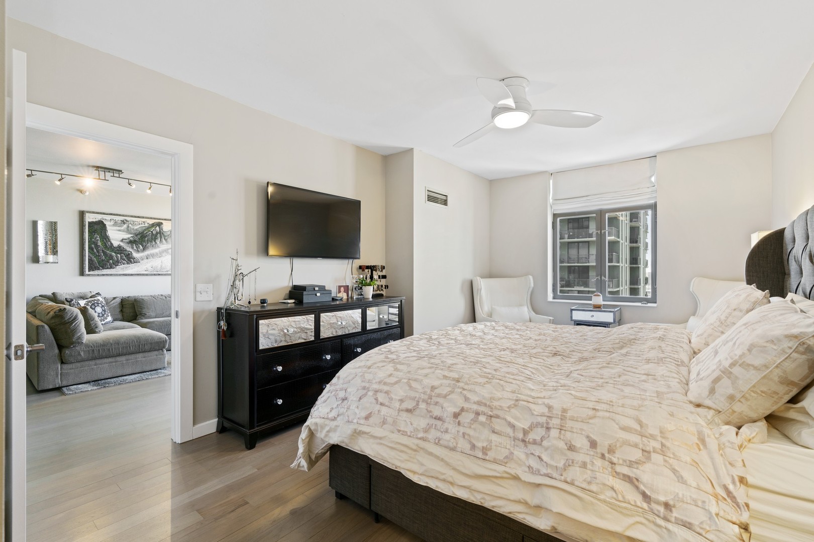 630 North State Street, Unit 2210 Chicago, IL 60654 - Photo 10 of 23 a bedroom with a bed and a flat screen television