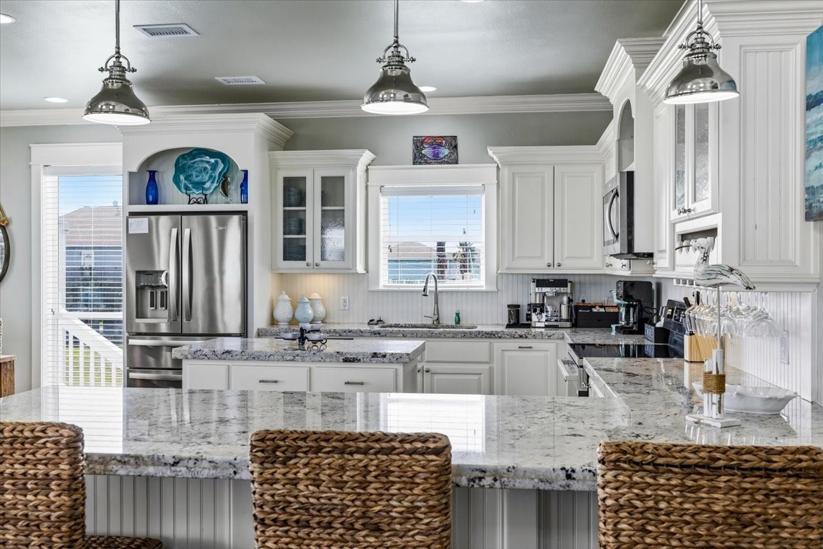 839 Eastview Crystal Beach, TX 77650 - Photo 13 of 44 a kitchen with stainless steel appliances granite countertop a stove sink cabinets and window