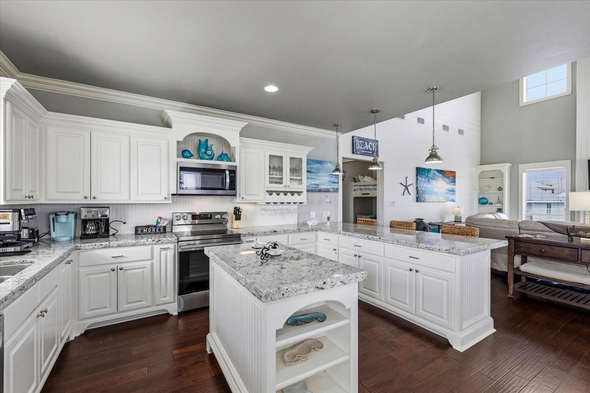 839 Eastview Crystal Beach, TX 77650 - Photo 16 of 44 a kitchen with a stove top oven sink and cabinets